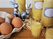 Bild eines Eierlikörs mit 2 Hasen und Eiern im Hintergrund