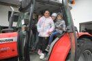 Sechs Kinder sitzen auf einem Traktor
